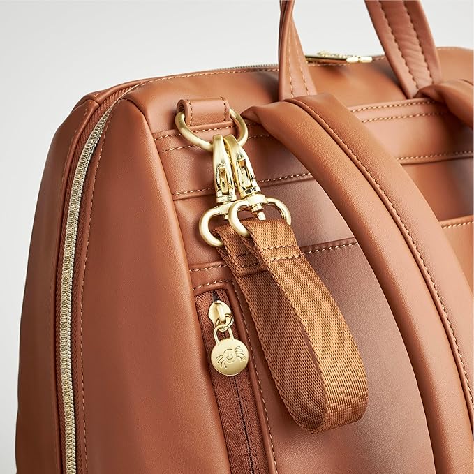 Itzy Ritzy Eras Diaper Bag Backpack – Large Capacity Backpack Diaper Bag Featuring Sleek Design, 15 Pockets, Changing Pad, Stroller Straps, and Luggage Sleeve (Cognac)
